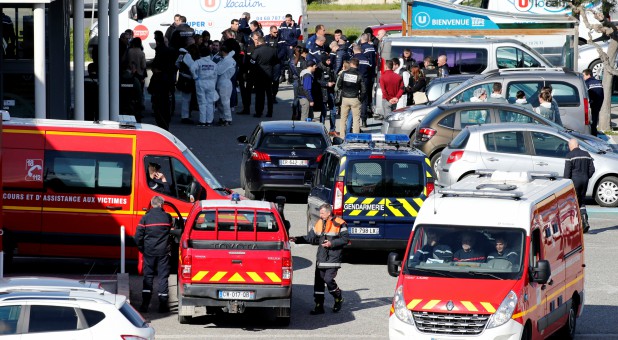 A general view shows rescue forces and police officers at a supermarket after a hostage situation in Trebes, France.