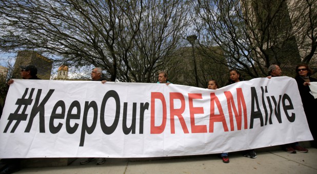 Members of the Border Network for Human Rights and Borders Dreamers and Youth Alliance (BDYA) hold a banner during protest outside a U.S. federal courthouse to demand that Congress pass a Clean Dream Act.