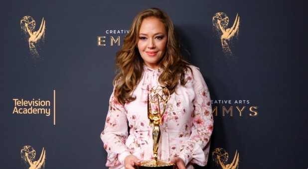 Leah Remini holds her Emmy Award for Outstanding Informational Series or Special for