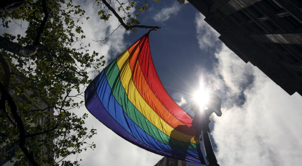 A rainbow flag flies above Market Street during the gay pride parade in San Francisco.