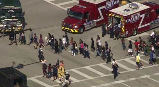 Students are evacuated from Marjory Stoneman Douglas High School during a shooting incident in Parkland, Florida, Feb. 14, 2018, in a still image from video.