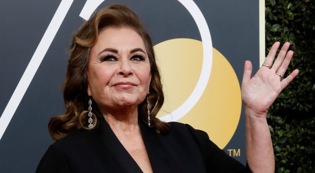 Actress Roseanne Barr waves on her arrival to the 75th Golden Globe Awards.