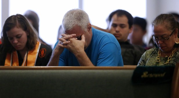Members of the community attend a prayer service at the Arcadia First Baptist Church in Santa Fe, Texas.