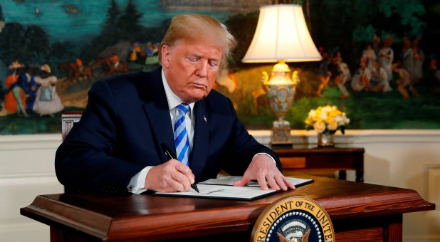 U.S. President Donald Trump signs a proclamation declaring his intention to withdraw from the JCPOA Iran nuclear agreement.