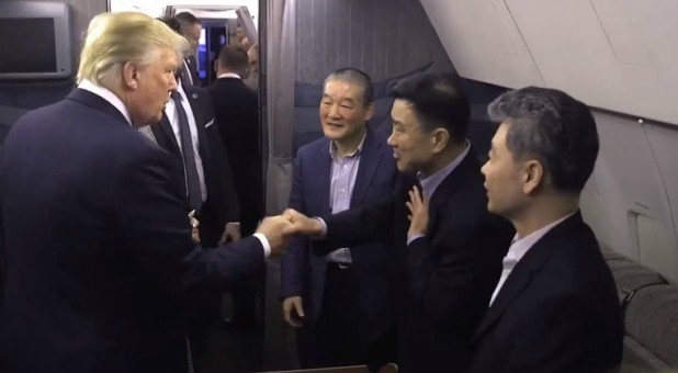 President Donald Trump greets the three men North Korea released.