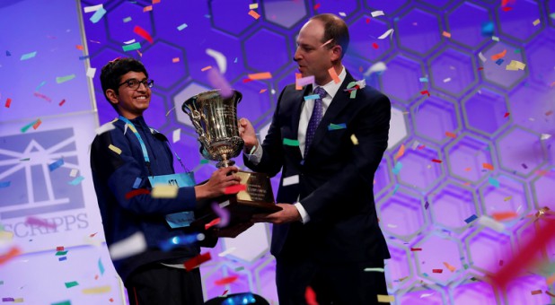 Karthik Nemmani celebrates with E.W. Scripps Company CEO Adam Symson after winning the Scripps National Spelling Bee.