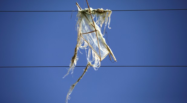 A kite flown by Palestinians, which was loaded with flammable materials, hangs on electricity wires in an area where such devices have caused blazes on the Israeli side of the border between Israel and the Gaza Strip.
