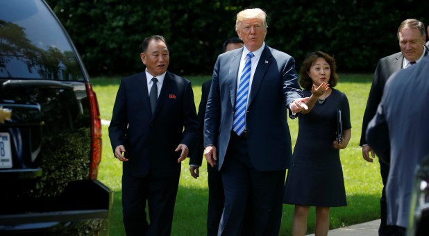 North Korea's envoy Kim Yong Chol talks with U.S. President Donald Trump as they walk out of the Oval Office after a meeting at the White House.
