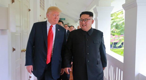 U.S. President Donald Trump walks with North Korean leader Kim Jong Un at the Capella Hotel on Sentosa island in Singapore.