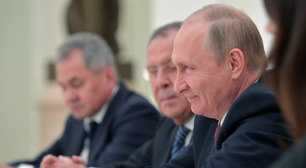 Russia's President Vladimir Putin smiles during a meeting U.S. National Security Adviser John Bolton.