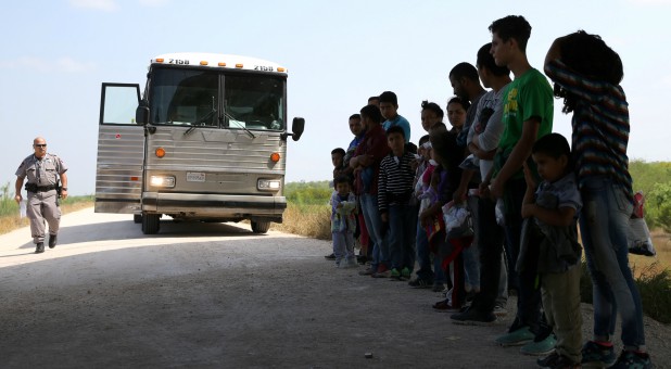 Immigrants who turned themselves in to border patrol agents after illegally crossing the border from Mexico into the U.S. wait to be transported for processing in the Rio Grande Valley sector.