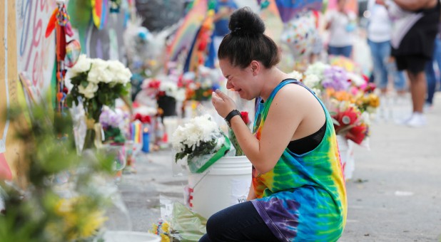 Chelsea Nylen reacts while visiting the memorial outside the Pulse Nightclub on the one-year anniversary of the shooting in Orlando, Florida, U.S., June 12, 2017.