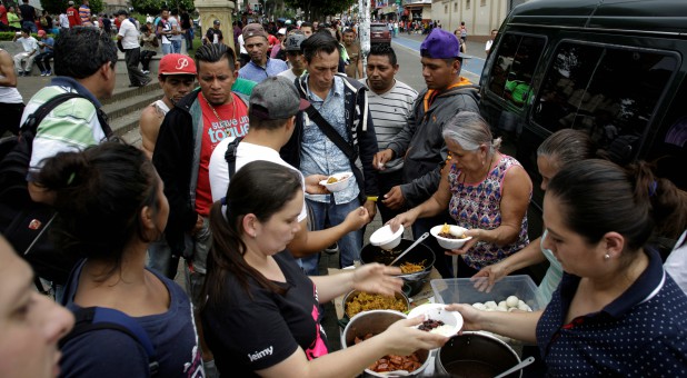 Nicaraguan refugees fleeing their country due to unrest receive food as they gather in San Jose, Costa Rica.