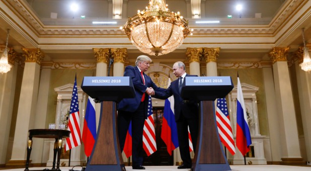 U.S. President Donald Trump and Russia's President Vladimir Putin shake hands.
