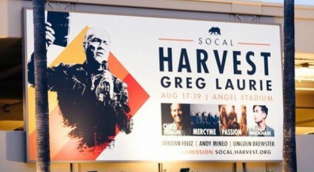 A billboard for the upcoming Harvest Crusade.