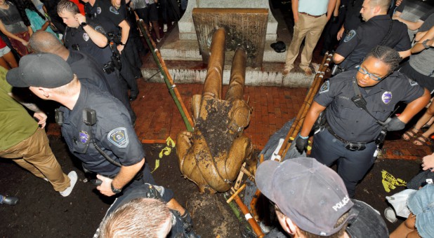 University of North Carolina police surround the toppled statue of a Confederate soldier, nicknamed