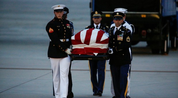 The casket containing the remains of Senator John McCain, R-Arizona, is carried by honor guards at Joint Base Andrews in Maryland.