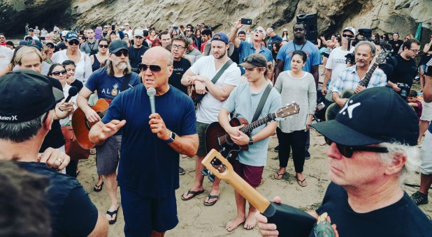 Greg Laurie speaks at a mass baptism in September.