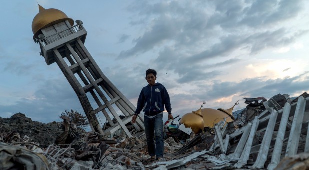 A resident walks at an area hit by the earthquake and tsunami in Palu, Central Sulawesi, Indonesia.