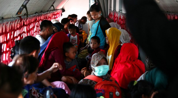 Local residents affected by the earthquake and tsunami are seen on a military aircraft at Mutiara Sis Al Jufri Airport in Palu, Central Sulawesi, Indonesia.