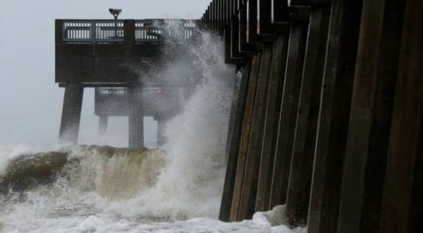 Waves crash along a pier as Hurricane Michael approaches Panama City Beach, Florida.