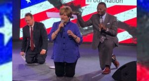 Cindy Jacobs, center, prays over the nation.