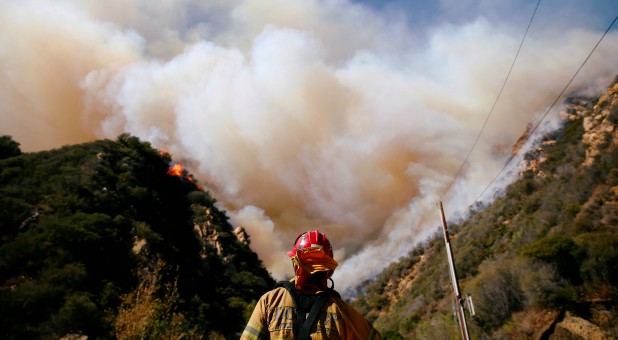 Firefighters battle the Woolsey Fire as it continues to burn in Malibu, California.