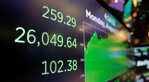 A screen displays the Dow Jones Industrial Average after the closing bell on the floor of the New York Stock Exchange (NYSE).
