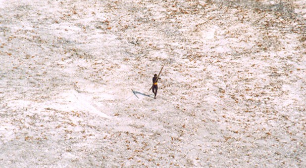 A Sentinel tribal man aims with his bow and arrow at an Indian Coast Guard helicopter as it flies over the island for a survey of the damage caused by the tsunami in India's Andaman and Nicobar archipelago.
