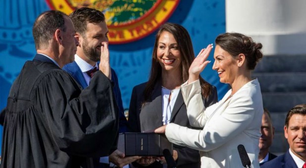 Nikki Fried, right, is sworn in as Florida's commissioner of agriculture on Jan. 8, 2019. Fried's left hand is placed on the first Hebrew Bible published in America.