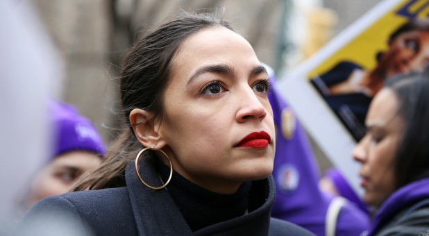 Rep. Alexandria Ocasio-Cortez, D-New York, looks on during a march organized by the Women's March Alliance in the Manhattan borough of New York City.