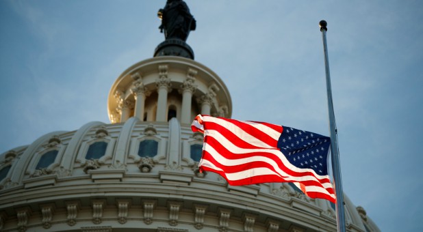 The American flag flies at half-mast outside the U.S. Capitol.