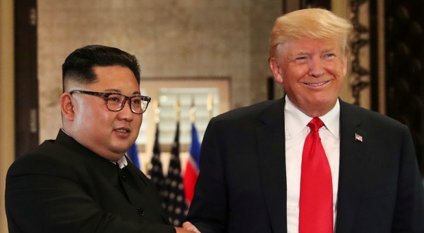 U.S. President Donald Trump and North Korea's leader Kim Jong Un shake hands after signing documents during a summit at the Capella Hotel on the resort island of Sentosa, Singapore.