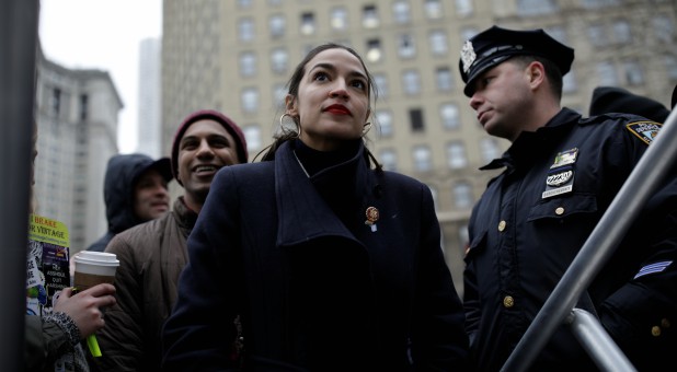 Representative Alexandria Ocasio-Cortez looks on as she awaits to be introduced to the crowd of supporters during the Women's March NYC.