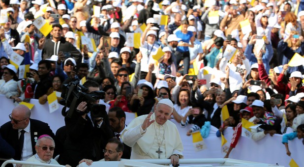 Pope Francis waves as he arrives to hold a mass at Zayed Sports City Stadium in Abu Dhabi, United Arab Emirates.