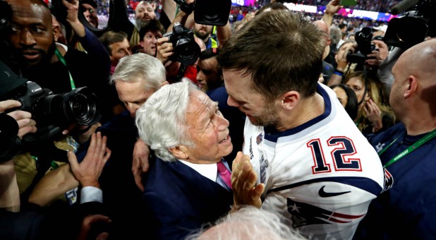 New England Patriots quarterback Tom Brady (12) celebrates with New England Patriots owner Robert Kraft.