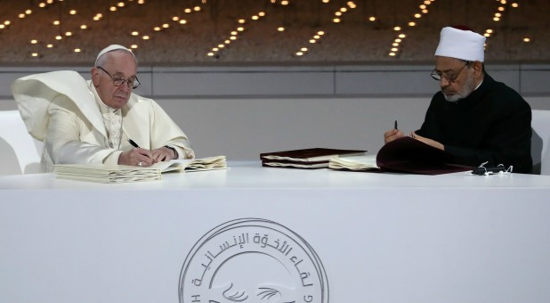 Pope Francis and Grand Imam of al-Azhar Sheikh Ahmed al-Tayeb signing a document on fighting extremism, during an inter-religious meeting.