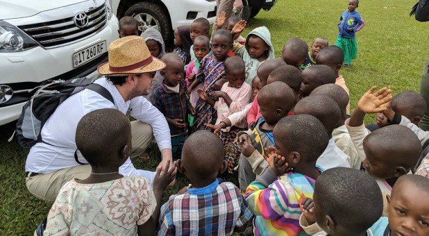 Brian Duss speaks with children who benefit from a World Vision water project.