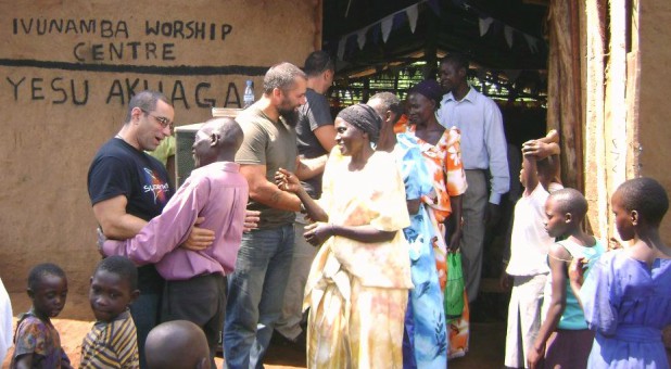Pastor Steve Ferrante and longtime Colorado friend Todd Oliver greet members of the Ivunamba Worship Centre outside their temporary mud church.