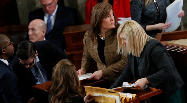 Congressional staff open cases containing Electoral College votes during a joint session of Congress.