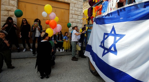 Israeli settlers celebrate the Jewish holiday of Purim, in Hebron in the Israeli-occupied West Bank.