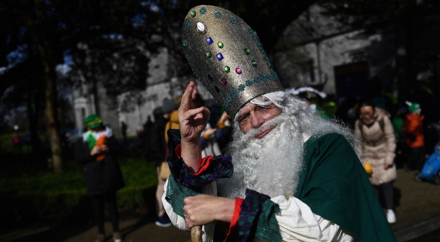 A man dressed as St. Patrick participates in the St. Patrick's Day parade in Galway, Ireland.