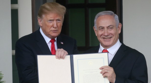 U.S. President Donald Trump and Israel's Prime Minister Benjamin Netanyahu hold up a proclamation recognizing Israel's sovereignty over the Golan Heights.