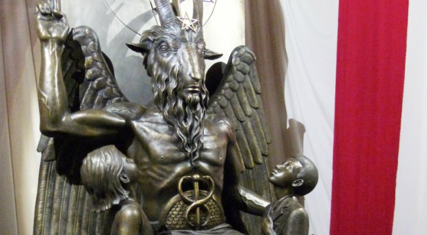 A one-ton, 7-foot (2.13-m) bronze statue of Baphomet—a goat-headed winged deity that has been associated with Satanism and the occult—is displayed by the Satanic Temple.