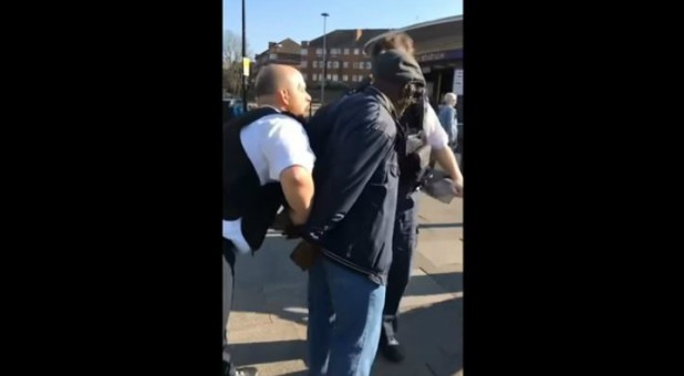 Police arrest a street preacher.