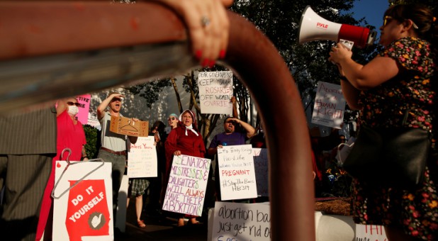 Pro-choice supporters protest in front of the Alabama State House as Alabama state Senate votes on the strictest anti-abortion bill in the United States.