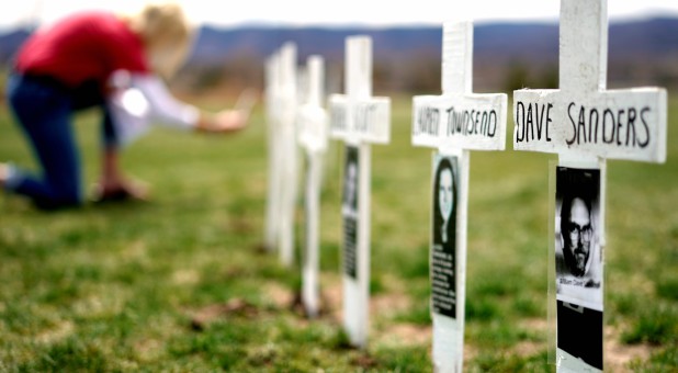 A woman looks at a line of crosses commemorating those killed in the Columbine High School shooting in Littleton, Colorado.