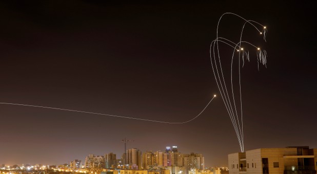 Iron Dome anti-missile system fires interception missiles as rockets are launched from Gaza toward Israel as seen from the city of Ashkelon, Israel.
