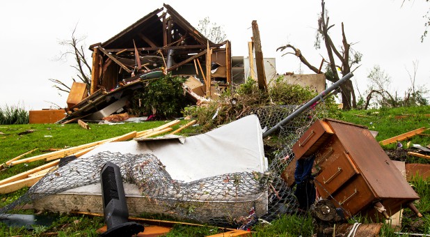 A mattress and dresser drawer are among the debris scattered on a lawn near a damaged house after several tornadoes reportedly touched down, in Linwood, Kansas.