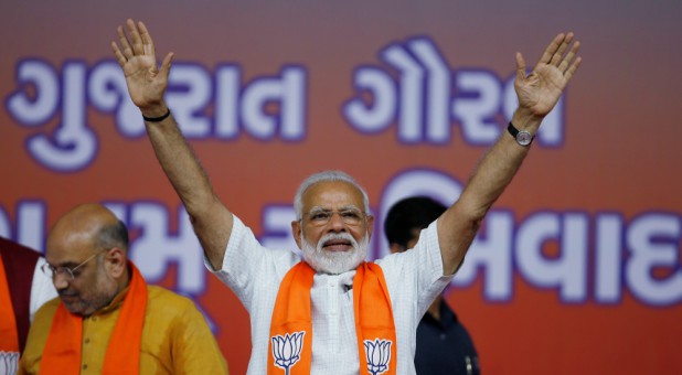 India's Prime Minister Narendra Modi gestures as he arrives to address his supporters at a public meeting in Ahmedabad, India.